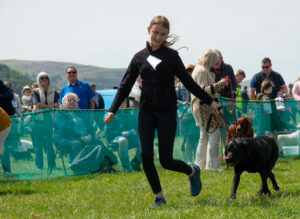 Child with Black Labrador at the dog show