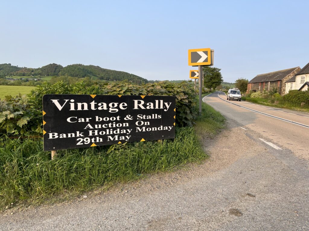 Main road with black sign and white writing, Vintage Rally.
